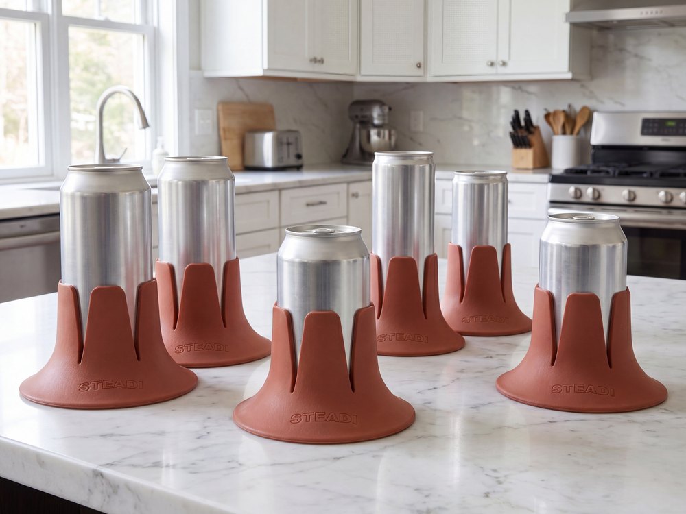 Six cans of different heights and widths standing in terracotta Steadi bases on a kitchen counter.